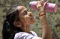 Meerut: A child pours water on her face on a hot summer day, in Meerut, Wednesday, May 1, 2024. (PTI Photo) (PTI05_01_2024_000072A)